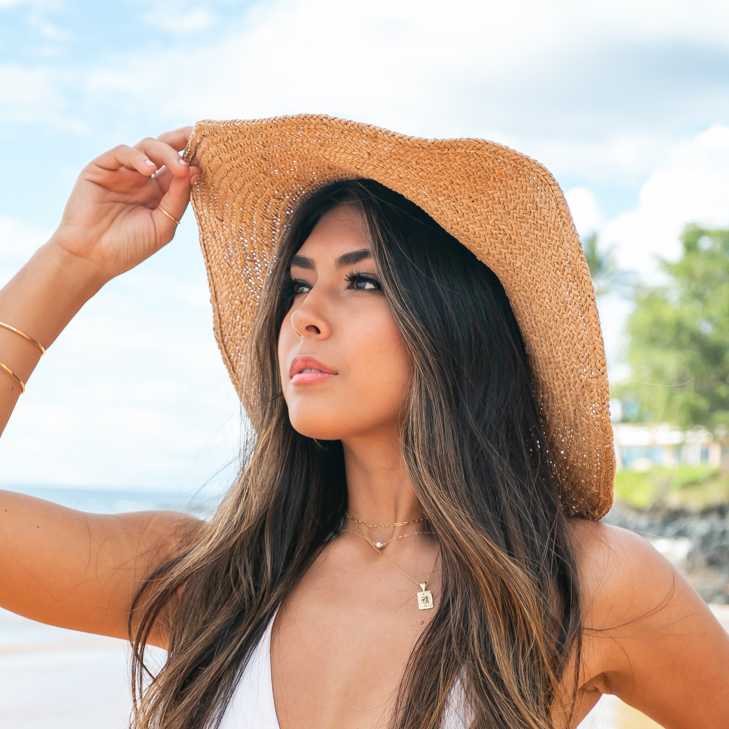 100% straw wide brim sun hat in khaki with Black bow accent