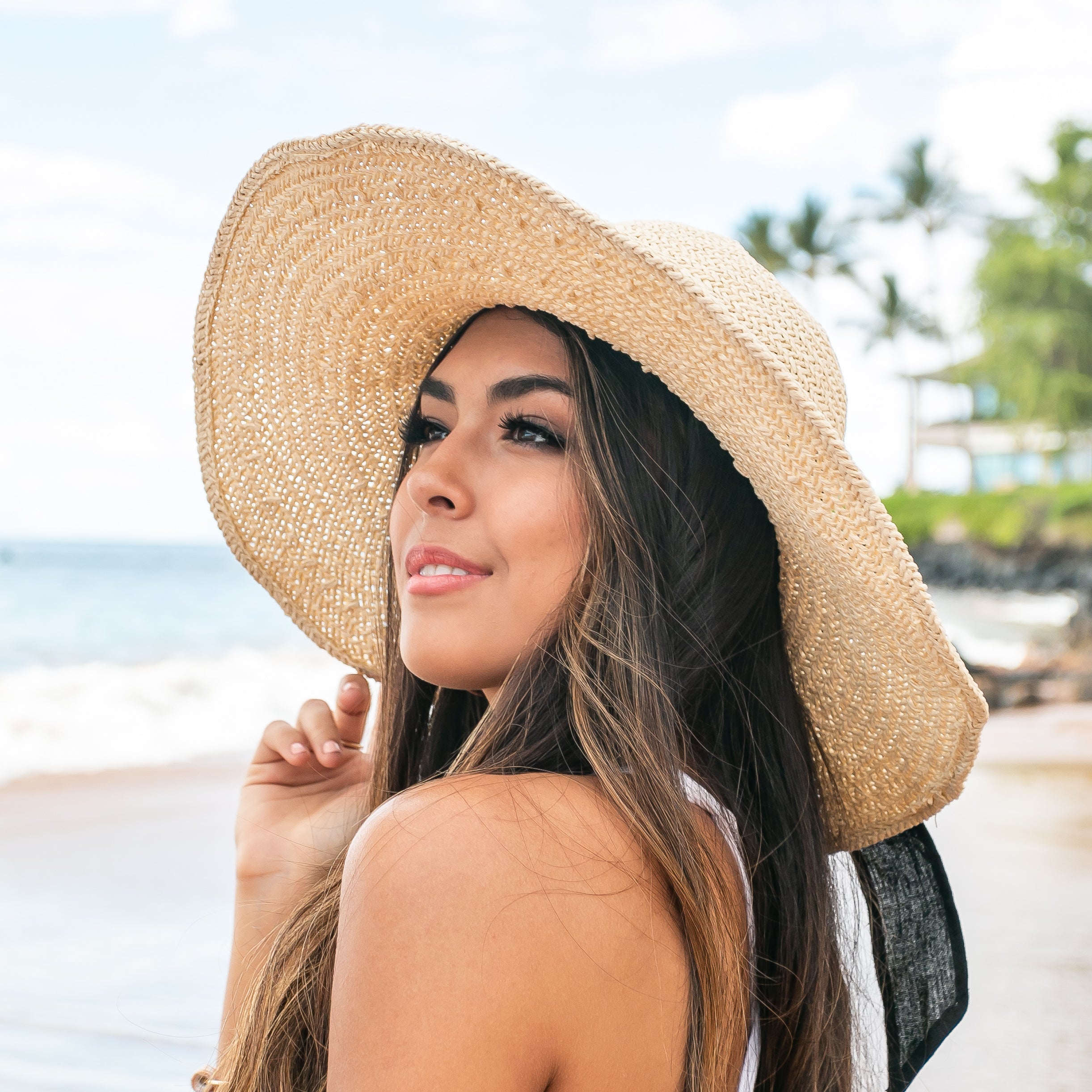 100% straw wide brim sun hat with Black bow accent