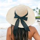 100% straw wide brim sun hat with Black bow accent