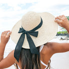 100% straw wide brim sun hat with Black bow accent