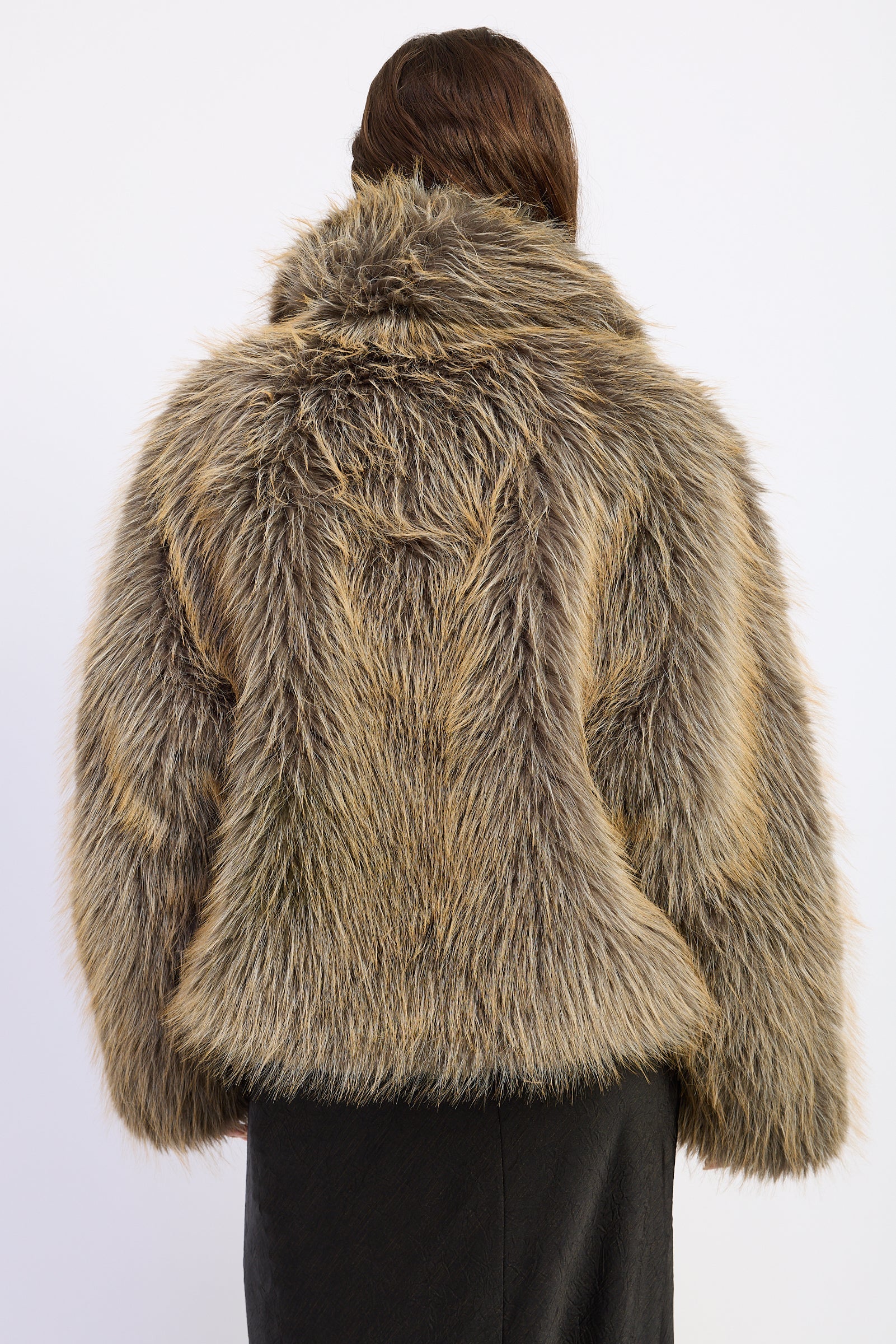 Back view of Montana Wild Faux Fur Coat featuring mixed earthy tones and relaxed hip length silhouette.