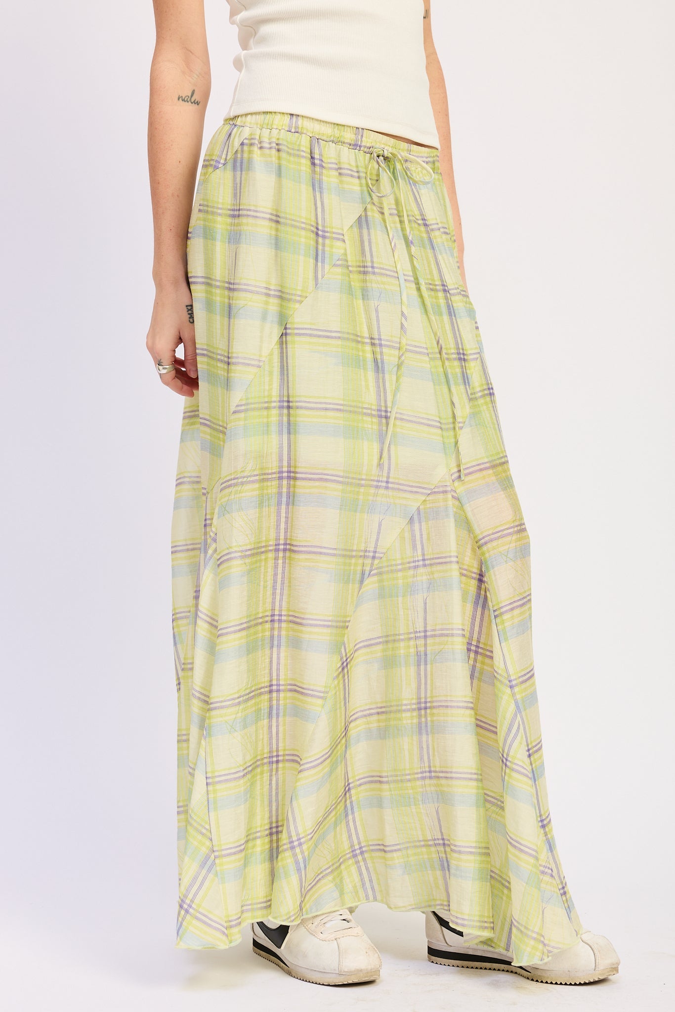 Angled view of lime green plaid maxi skirt
