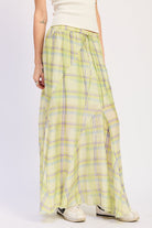 Angled view of lime green plaid maxi skirt