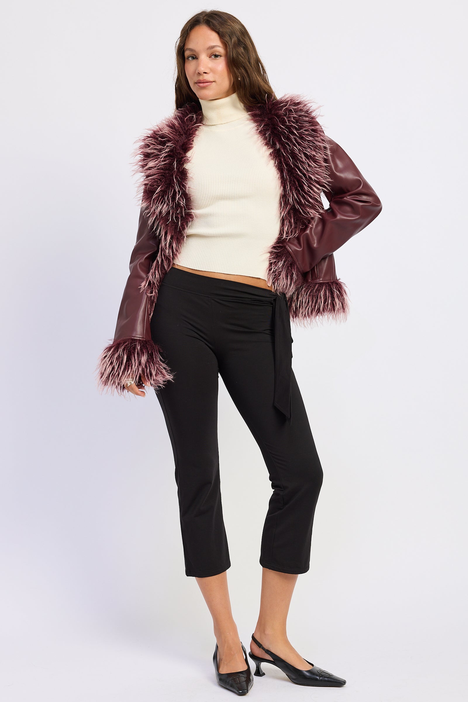 Burgundy faux fur trim jacket styled with a cream turtleneck and black pants, full outfit view.