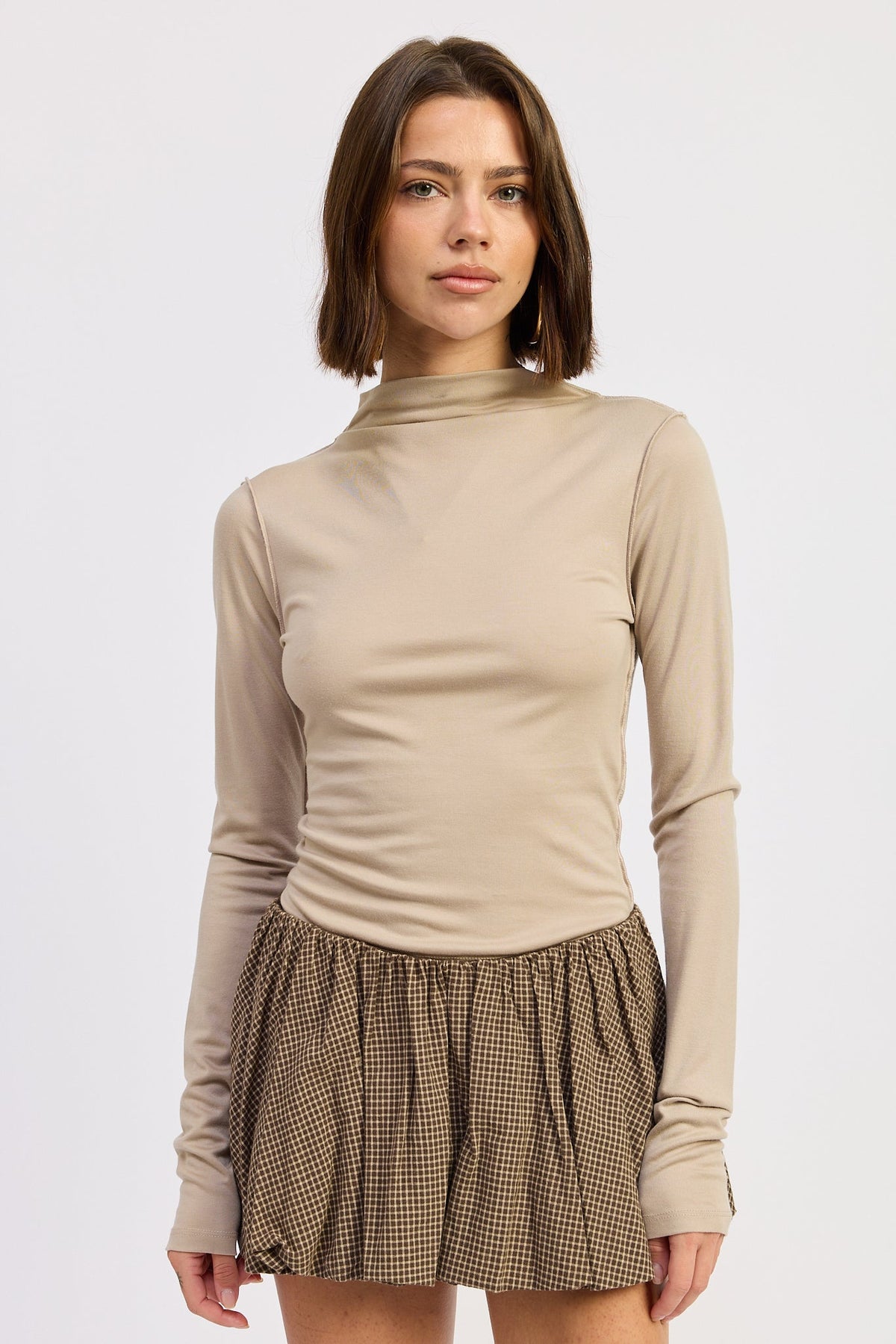 Second Skin Latte Mock Neck Top with long sleeves, fitted silhouette and exposed seam detailing.
