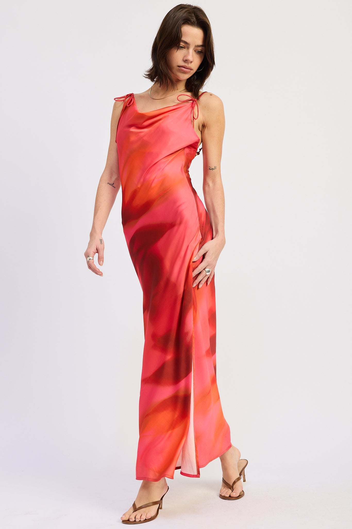 Side view of coral and red floral maxi dress with cowl neckline and shoulder ties
