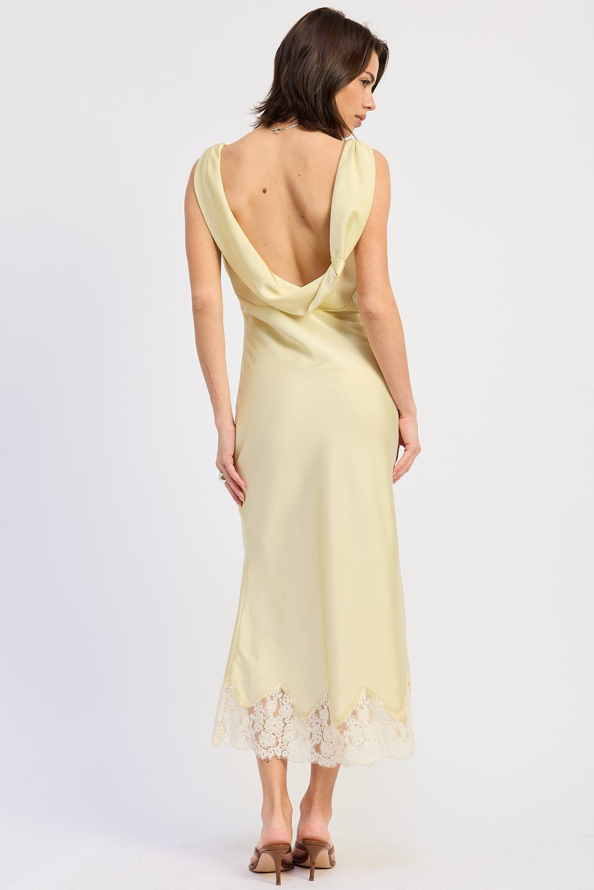 Woman wearing bias-cut satin midi dress with lace hem in Butter Yellow.