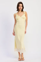 Woman wearing bias-cut satin midi dress with lace hem in Butter Yellow.