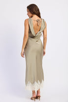 Woman wearing bias-cut satin midi dress with lace hem in Light Olive.