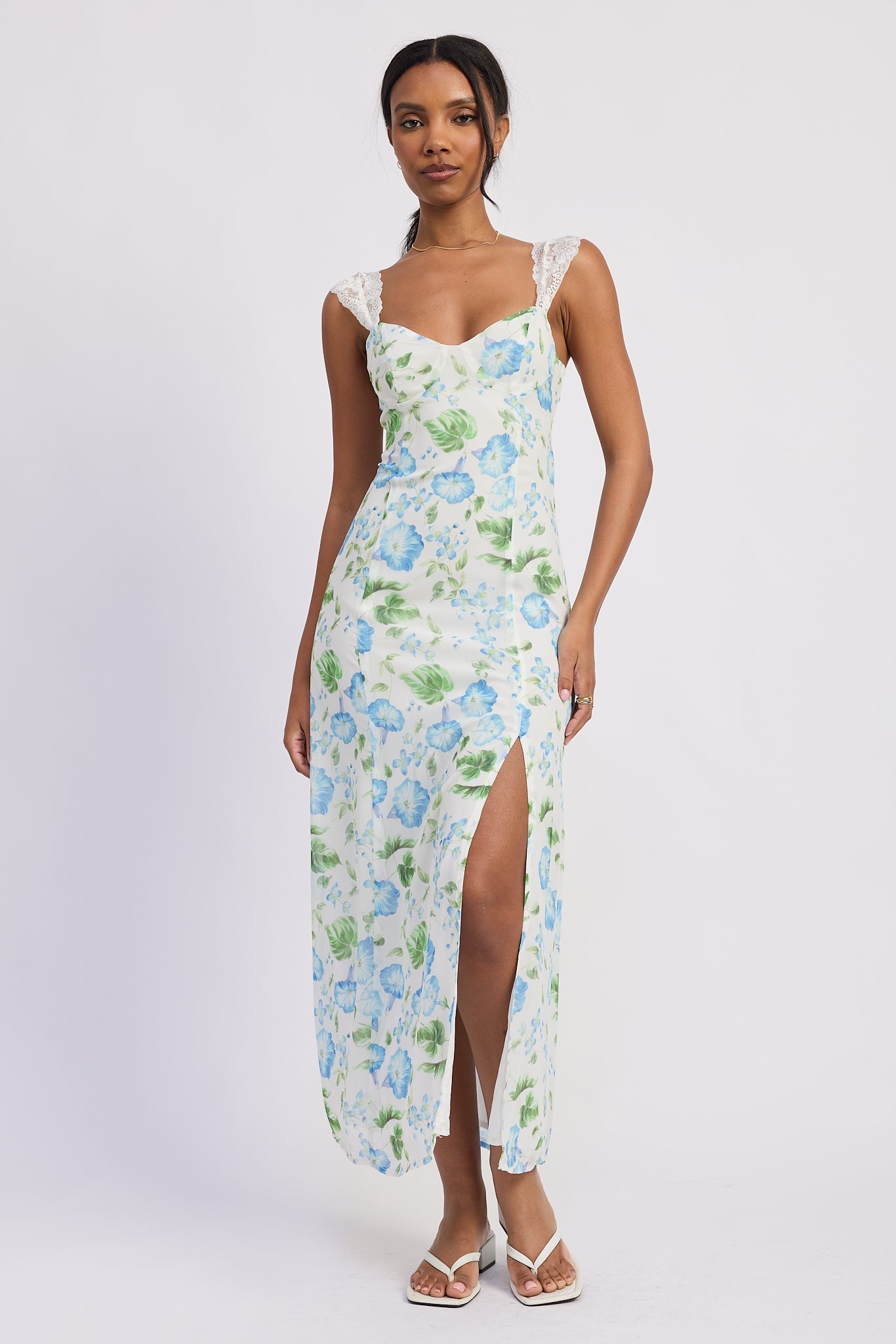 Full length front view of blue and white floral chiffon maxi dress styled with white heels, AVAH