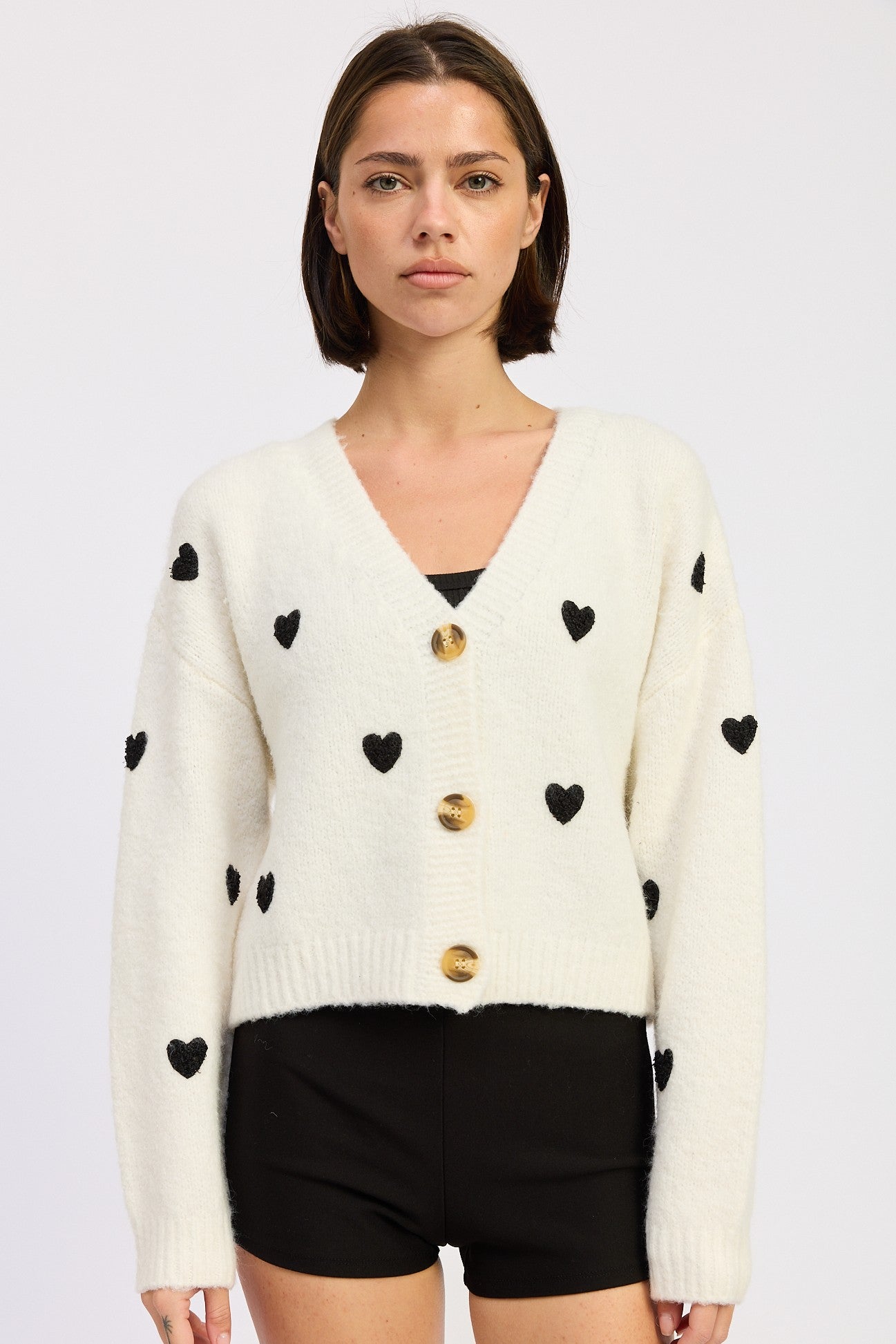 Ivory black heart cardigan front view on model
