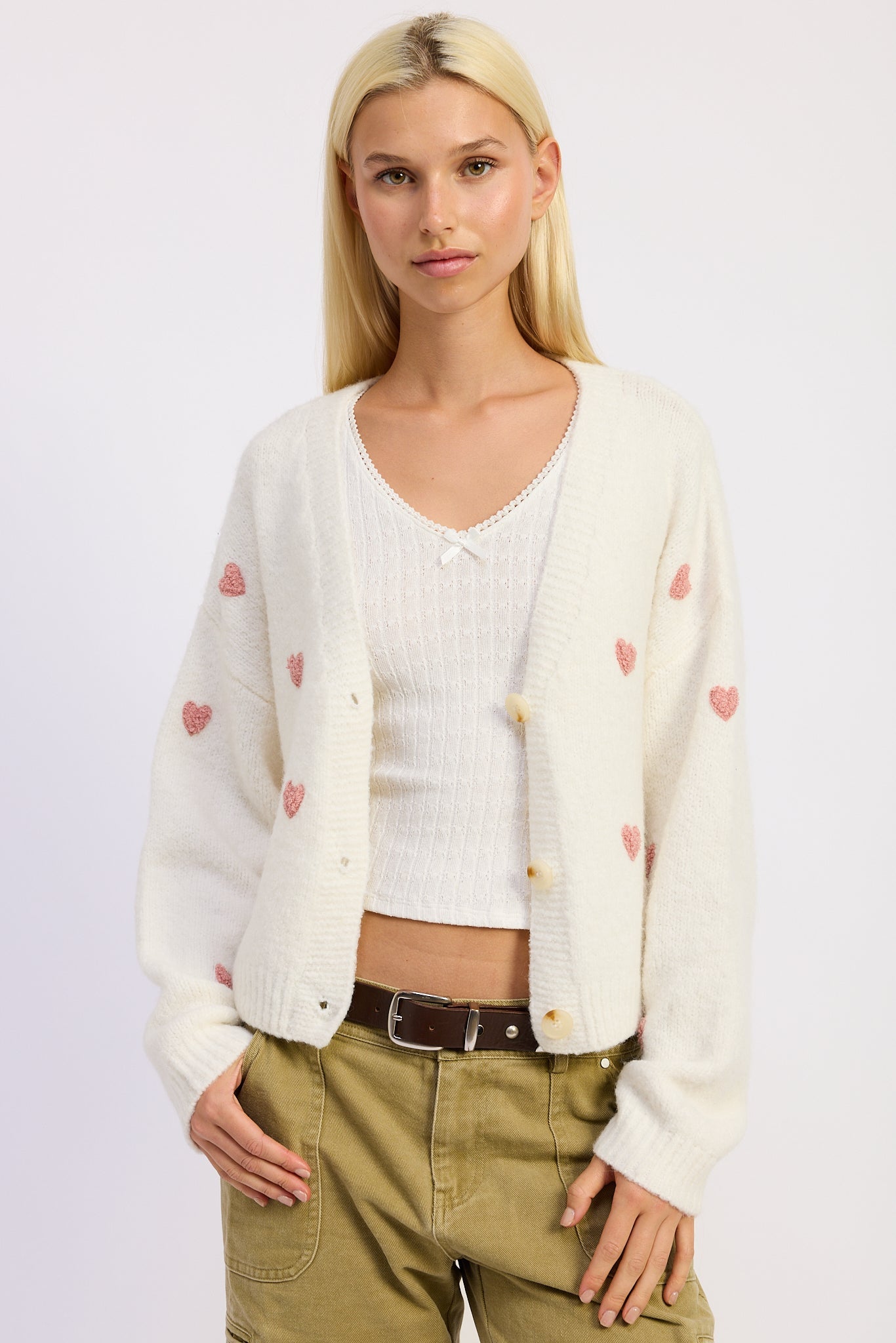 Ivory pink heart cardigan front view on model
