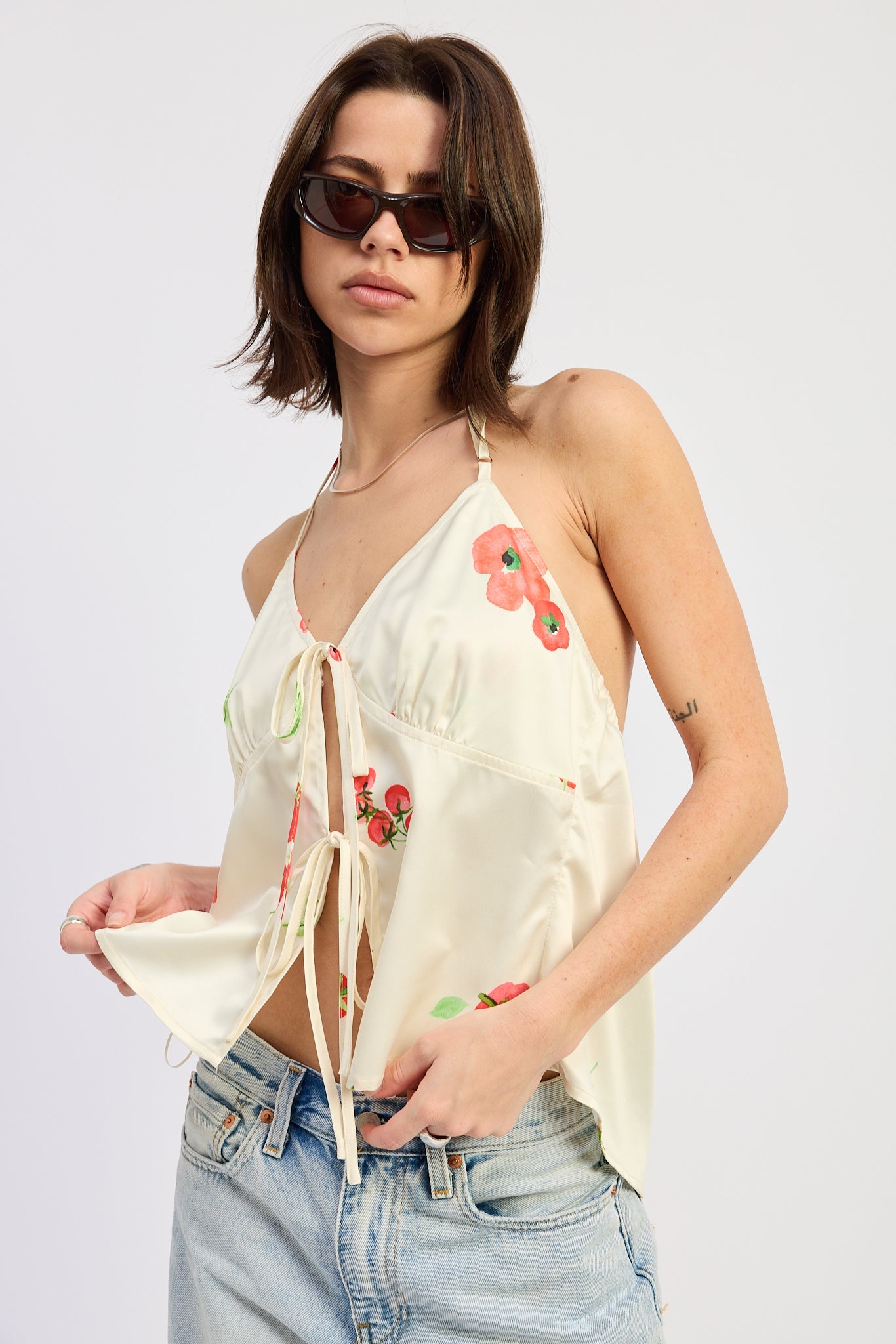 Ivory tie front halter top with painterly floral print and open back.