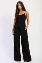 Marlowe Black Wide Leg Pants styled with a black camisole, showing relaxed full length silhouette and front pleats.