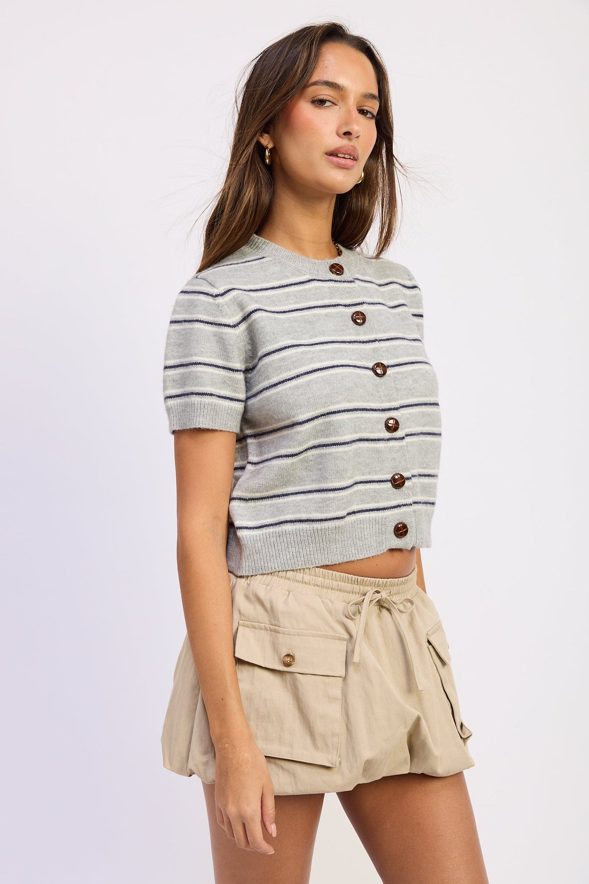 Side view of Varsity Lines short sleeve cardigan in Heather Grey Combo showing cropped fit and striped knit.