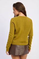 Back view of moss green knit cardigan with long sleeves and ribbed cuffs and hem.