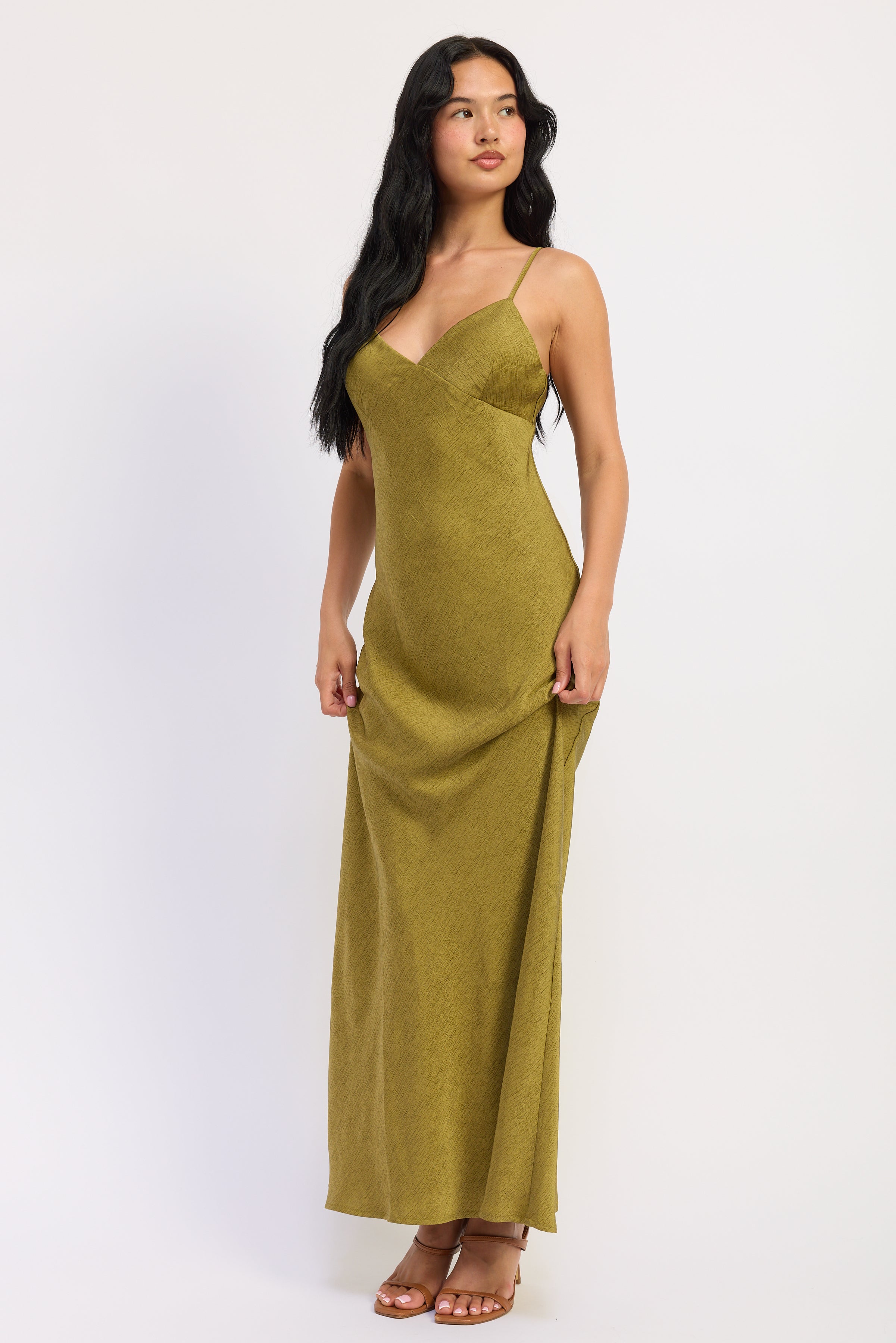 Angled front view of avocado green satin maxi dress showing fitted bodice and softly flared skirt.
