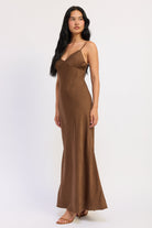Side view of Sienna Satin Slip Dress in brown showing textured satin fabric and gently flared hem.
