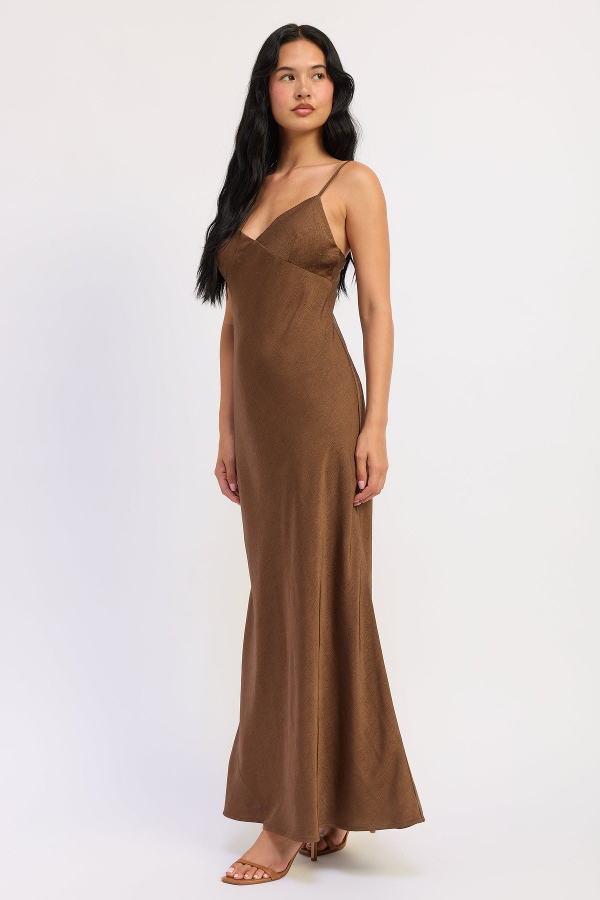 Side view of Sienna Satin Slip Dress in brown showing textured satin fabric and gently flared hem.