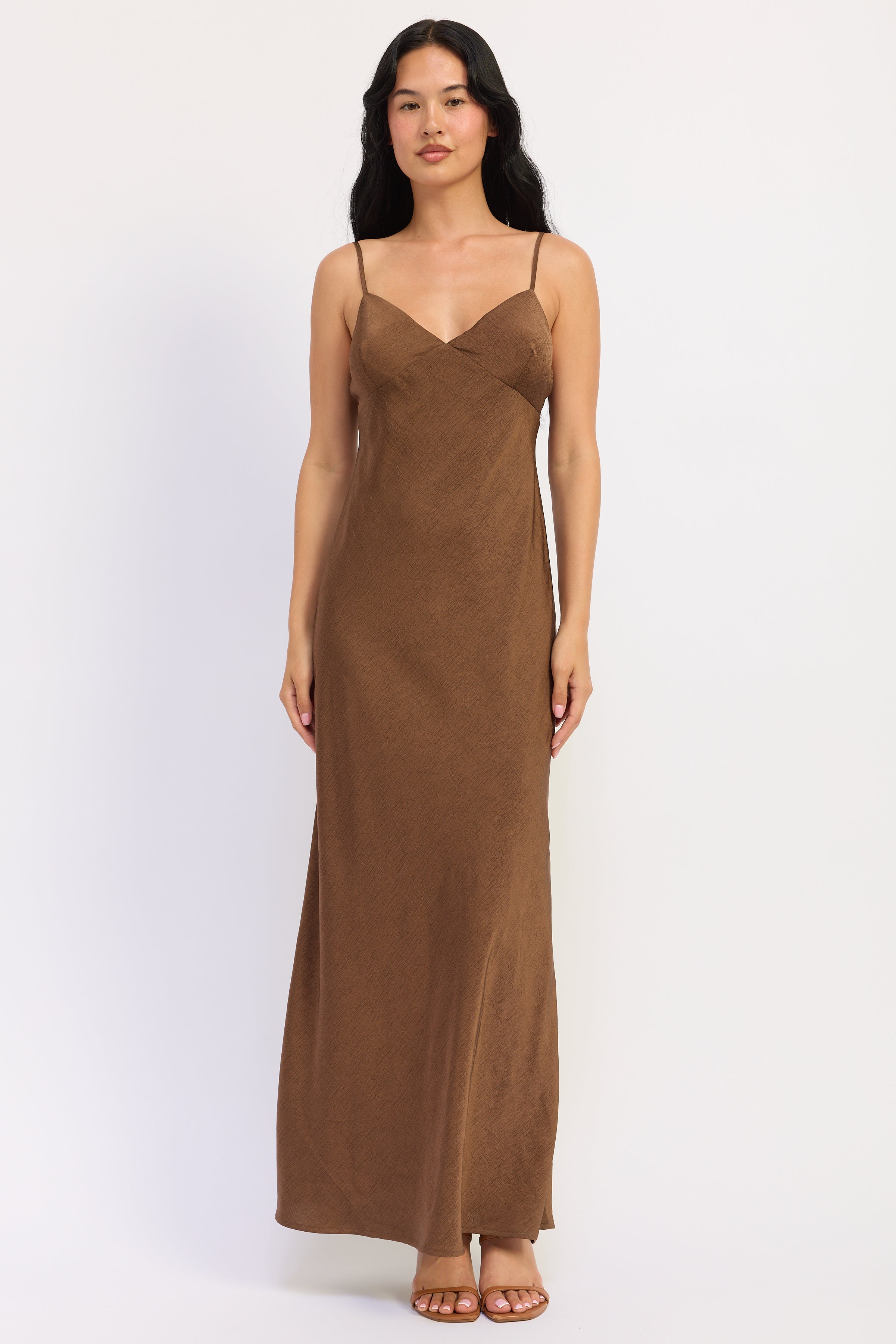 Sienna Satin Slip Dress in warm brown with V neckline, spaghetti straps and fluid maxi silhouette, front view.