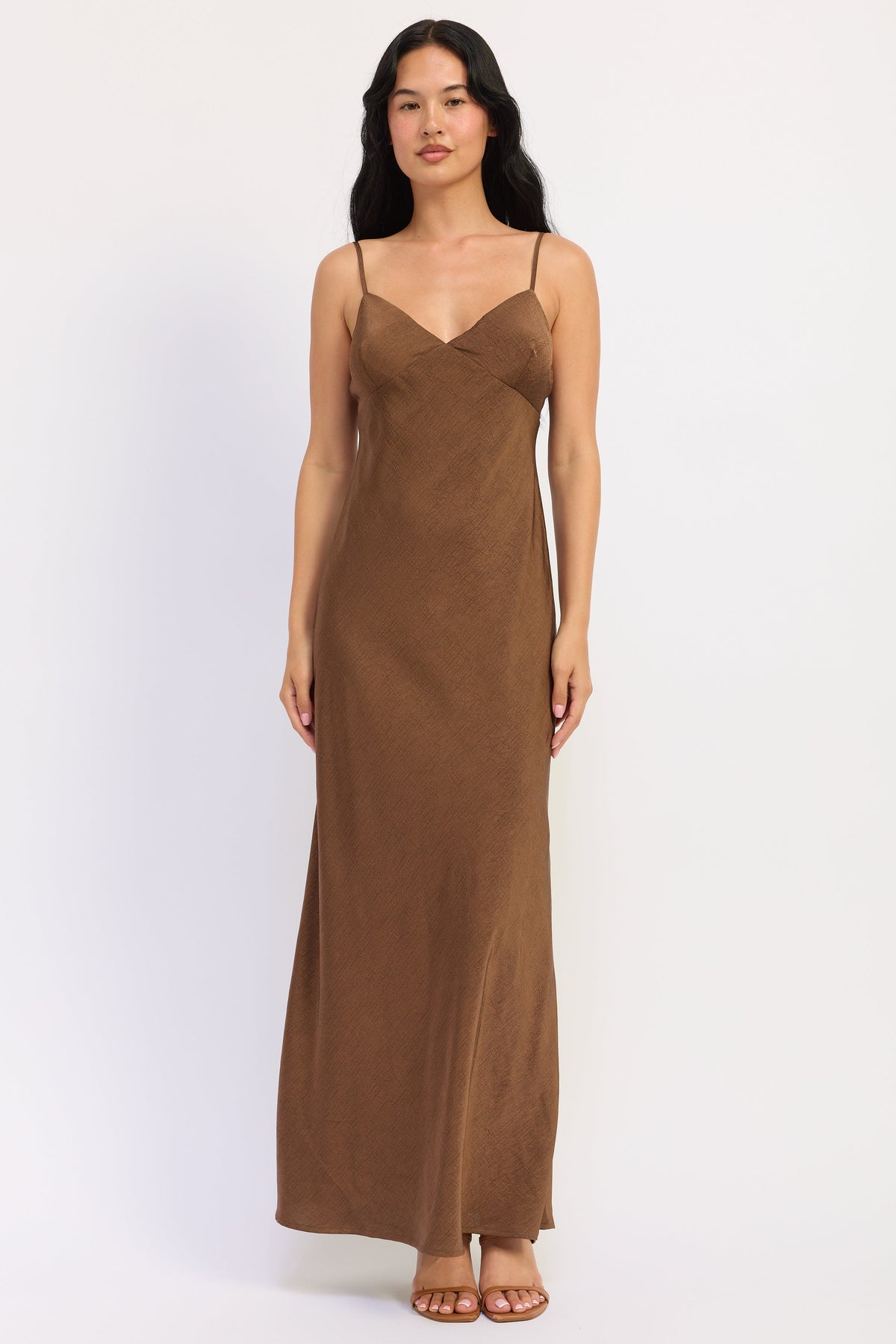 Sienna Satin Slip Dress in warm brown with V neckline, spaghetti straps and fluid maxi silhouette, front view.