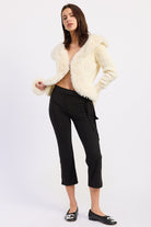 1. Aspen Faux Fur Trim Knit Cardigan styled open with black cropped pants, full length model view.