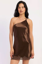 Woman wearing dark chocolate satin mini dress with lace trim.