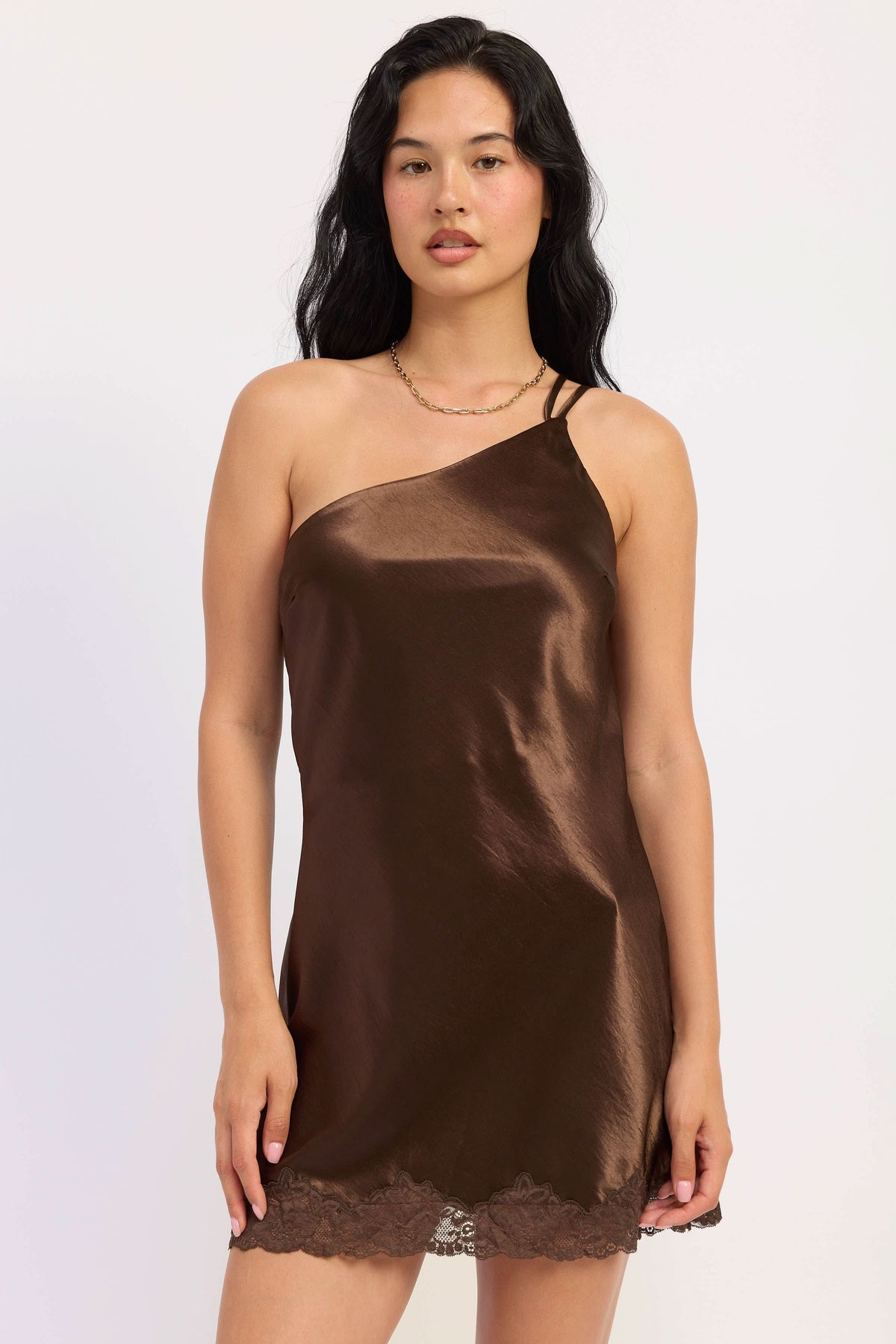 Woman wearing dark chocolate satin mini dress with lace trim.