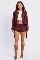 Wine faux suede fringe jacket with collared neckline, front pockets and tonal whipstitch detailing
