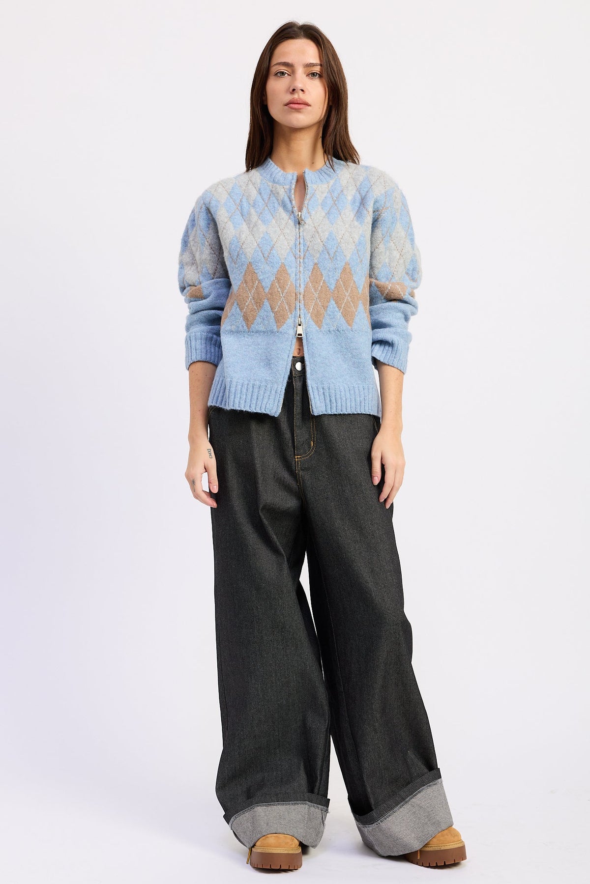 Blue Skies Argyle Zip Cardigan in baby blue with grey and camel diamond pattern, styled with dark wide leg jeans.