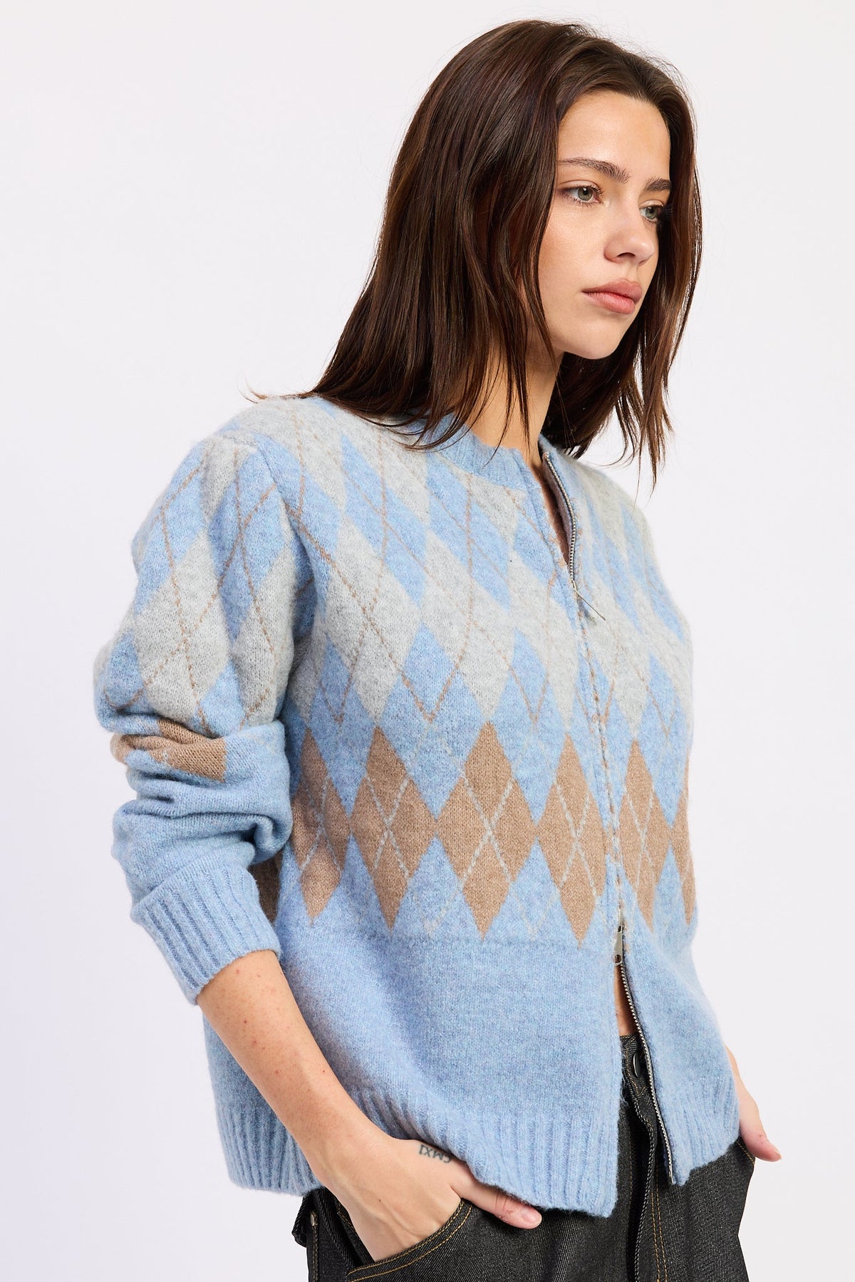 Side view of baby blue argyle zip cardigan showing relaxed fit, long sleeves and diamond knit design.