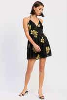 Black halter mini dress with gold floral print, front full-body view-AVAH