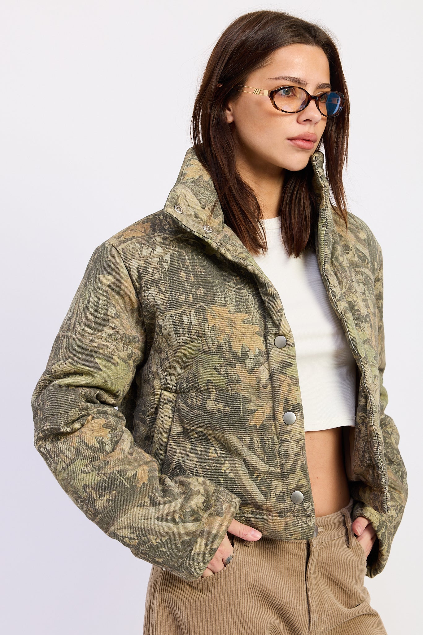 Wildwood camo puffer jacket showing cropped silhouette, high collar and woodland print.