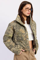 Wildwood camo puffer jacket showing cropped silhouette, high collar and woodland print.