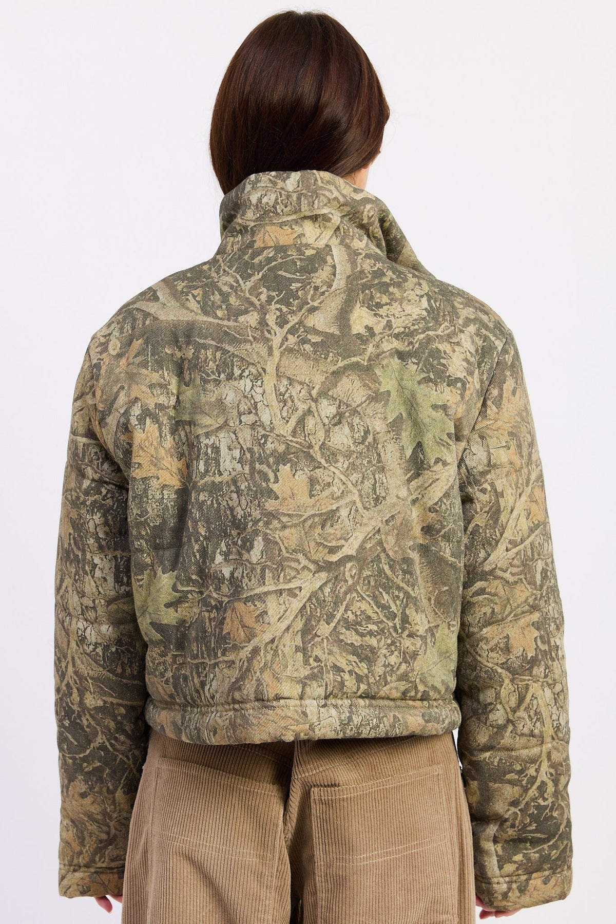 Back view of Wildwood camo puffer jacket showing woodland tree print and cropped hem.