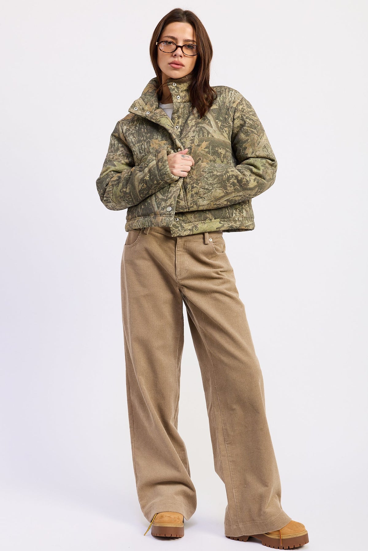 Wildwood camo puffer jacket styled with wide leg corduroy pants, full front view.
