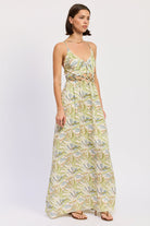 Green tropical print cutout maxi dress with V neckline and flowing skirt