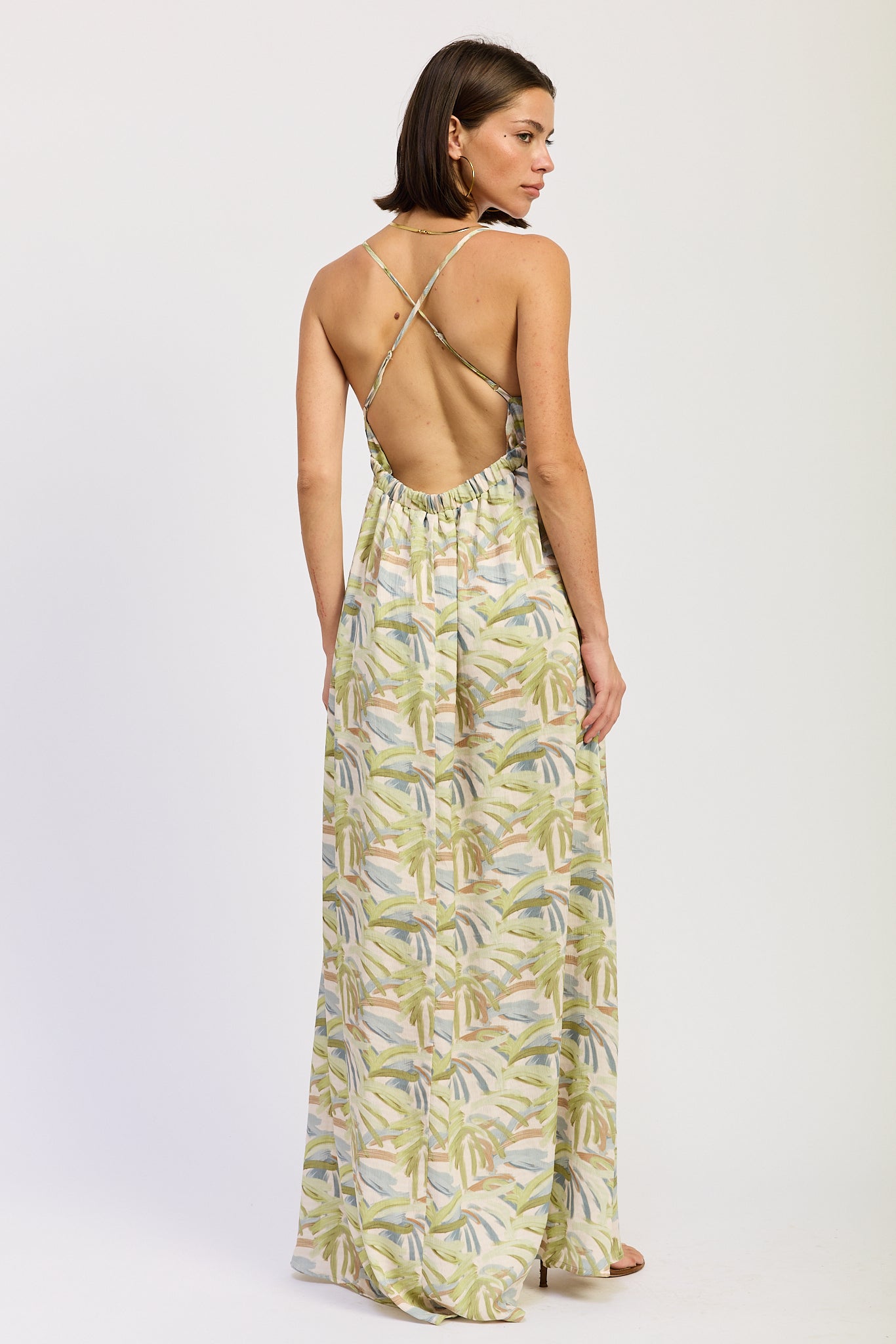 Green tropical print cutout maxi dress with V neckline and flowing skirt