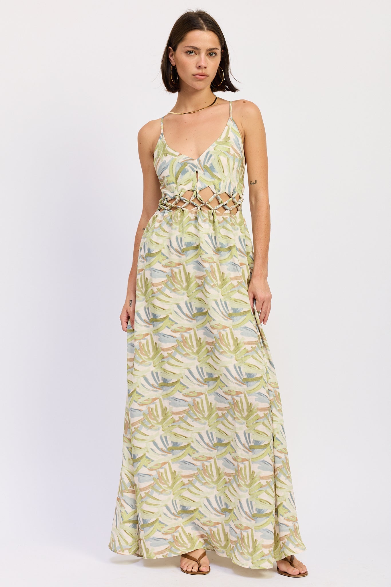 Green tropical print cutout maxi dress with V neckline and flowing skirt