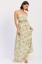 Green tropical print cutout maxi dress with V neckline and flowing skirt