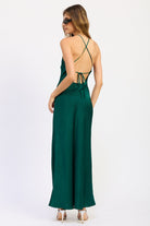 Back view of emerald green Seraphina Satin Halter Maxi Dress featuring open back, crisscross straps and adjustable tie