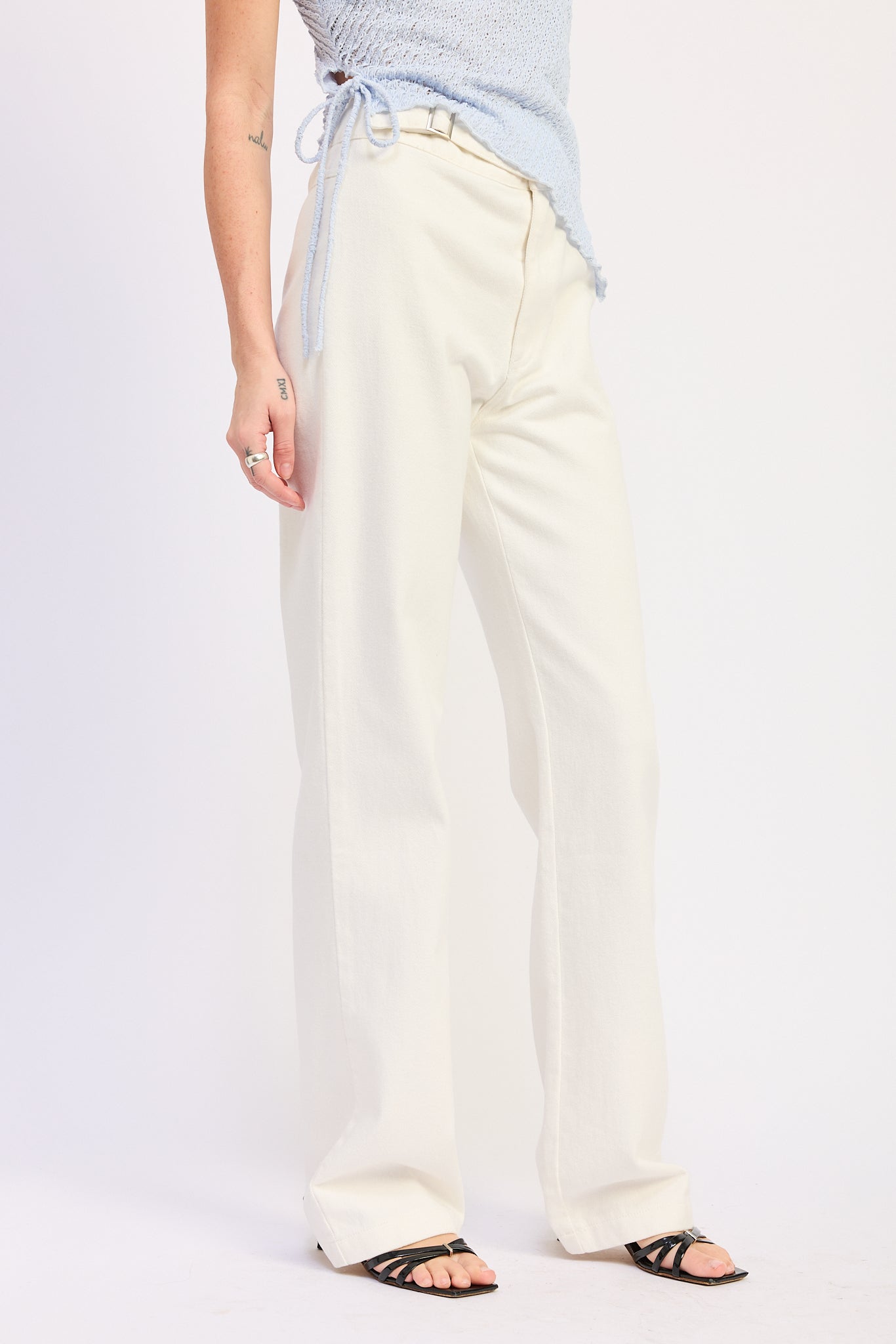 Woman wearing Buckle Wide Leg cream color cotton Pants on a white background front view