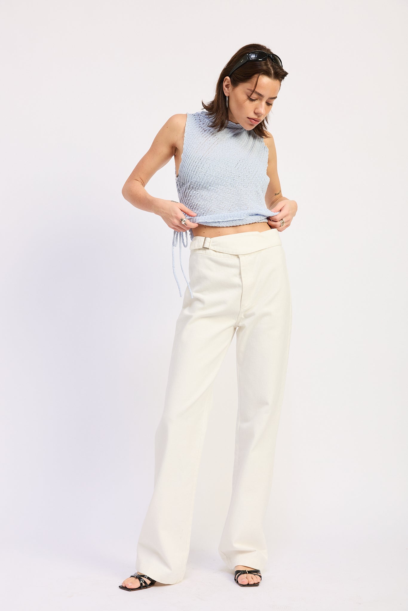 Woman wearing Buckle Wide Leg cream color cotton Pants on a white background front view