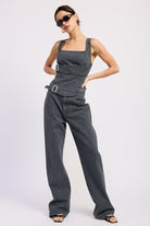 Woman wearing Buckle Wide Leg denim color cotton Pants on a white background front view