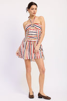 Woman wearing a striped halter mini dress front view with multicolor vertical stripes on a white background front view