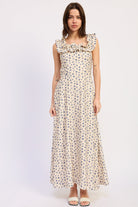 Woman wearing an Ivory floral ruffle maxi dress front view with blue floral print on a white background