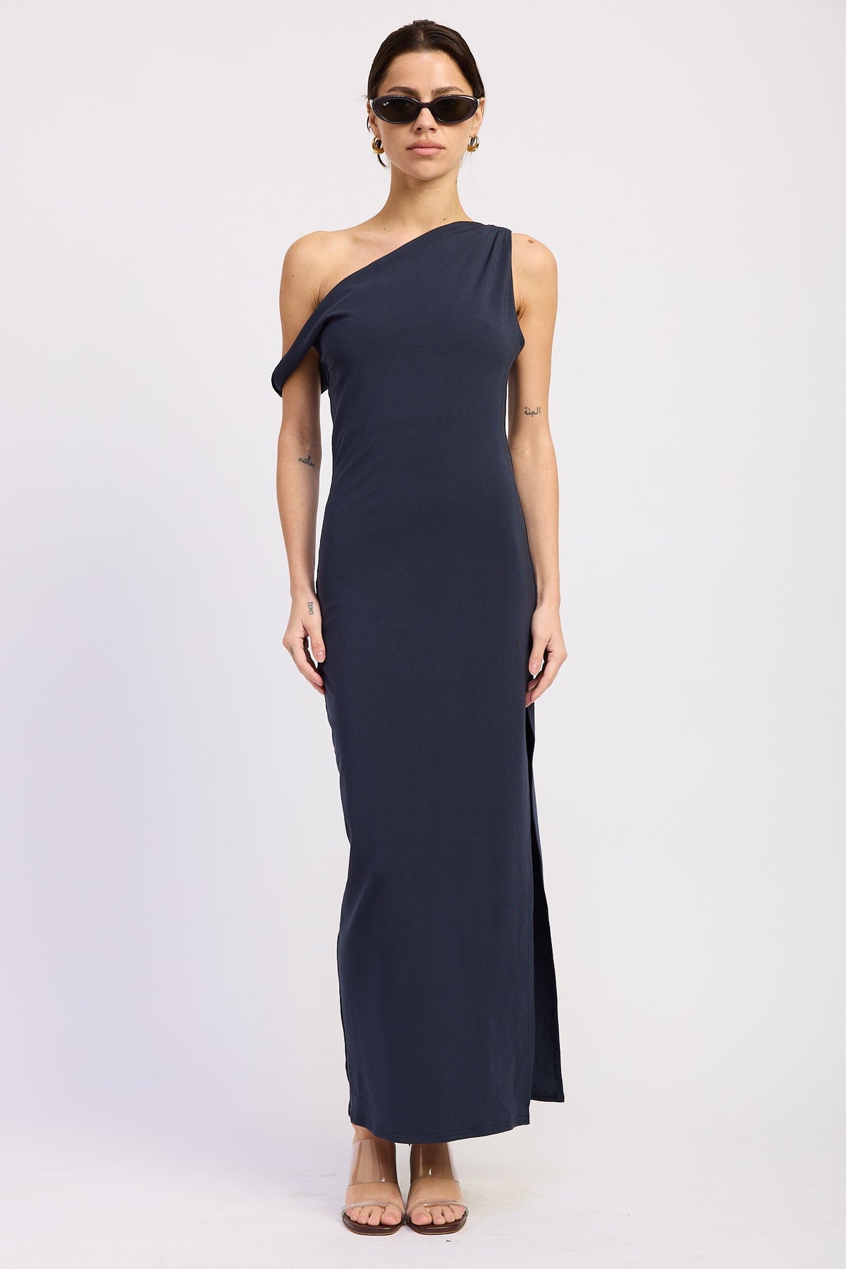 Navy one shoulder maxi dress with asymmetrical draped neckline and long fitted silhouette, front view.