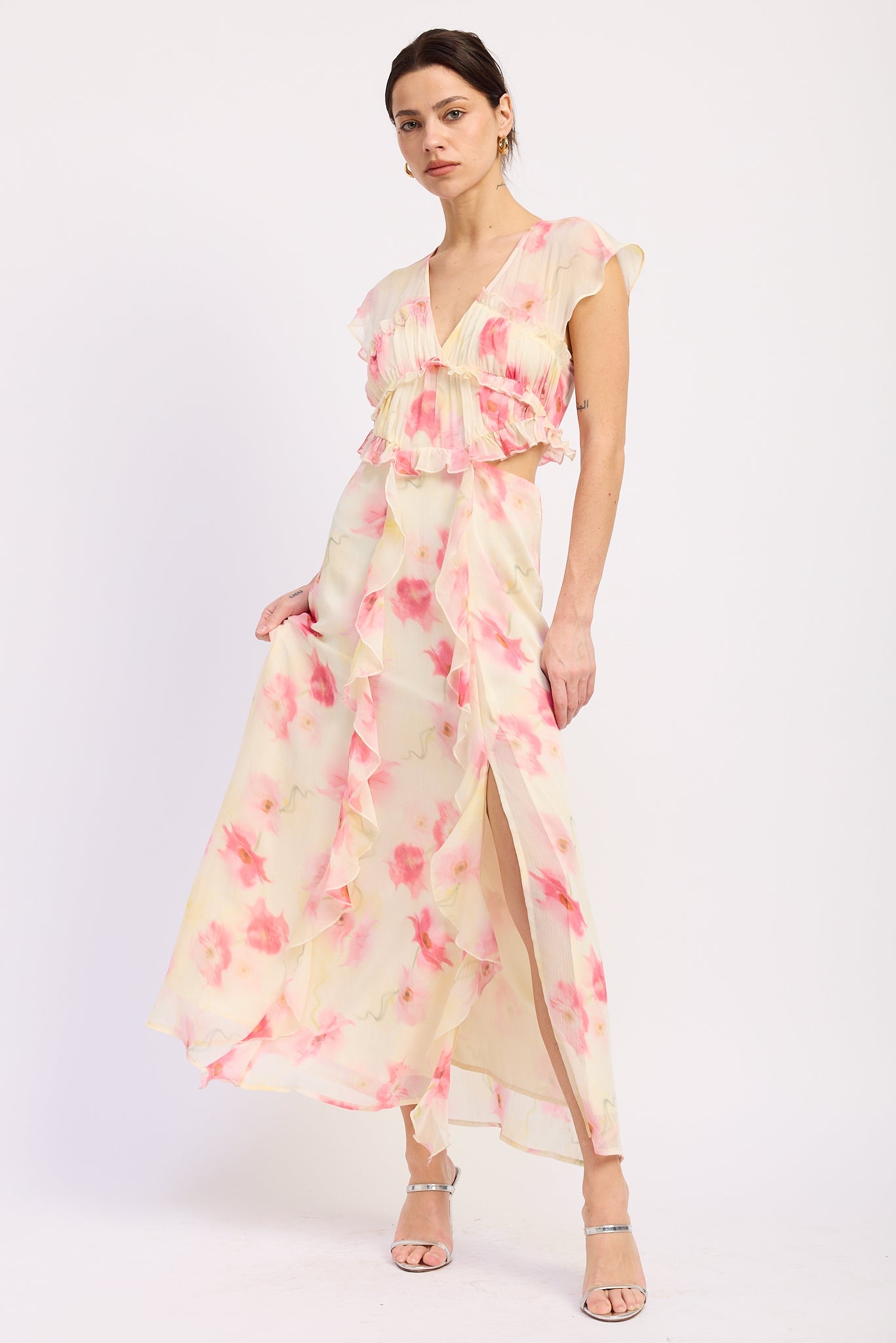 Ivory and pink floral ruffle maxi dress with V neckline, flutter sleeves, waist cutouts and front slit - angled front view
