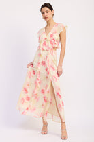 Ivory and pink floral ruffle maxi dress with V neckline, flutter sleeves, waist cutouts and front slit - angled front view
