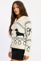 Side view of Doxie Darling Dachshund Cardigan showing black dachshund graphic and looping design on the sleeve.